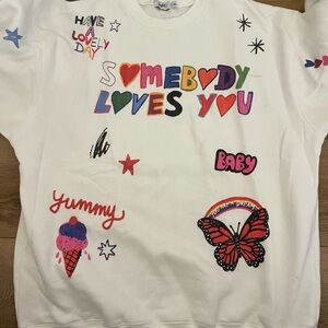 White and Red Graphic Sweatshirt with Playful Designs